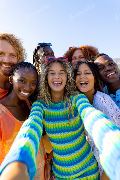 Preview: Happy diverse group of friends having party, taking a selfie in garden