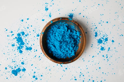 Preview: top view of blue holi paint in bowl isolated on white, Hindu spring festival