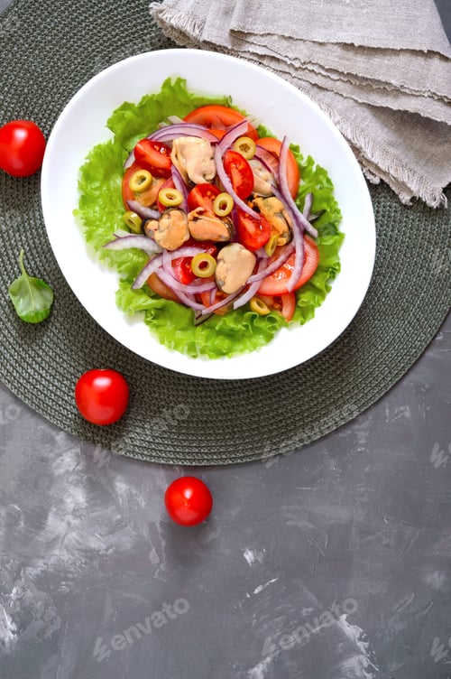 Preview: Salad of marinated mussels, fresh tomatoes, red onions, olives in a white bowl. The top view