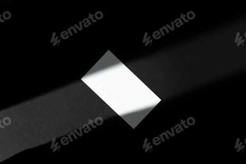 Preview: Single businesscard with copy space on black background. Photo with shadow