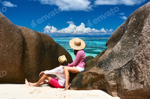 Preview: Couple Relaxing Among Granite Rocks On A Tropical Beach Anse Source D'Argent At Seychelles, La
