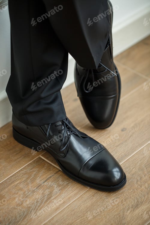 Preview: Male businessman puts on stylish shoes. Clothes for men