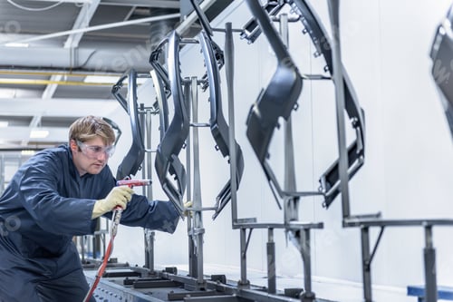 Preview: Worker cleaning automotive parts in spray paint factory