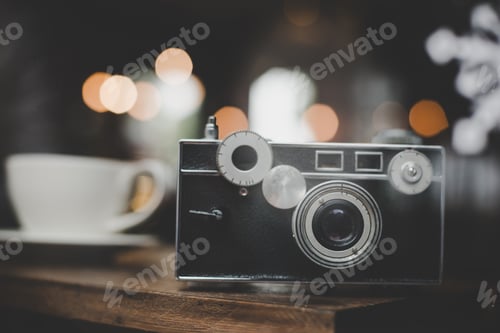 Preview: Vintage or retro camera on wooden table at cafe.