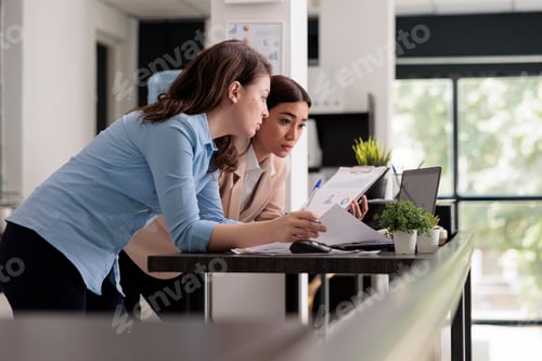 Preview: Start up company employees discussing financial report