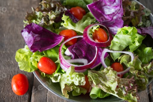Preview: Close up of fresh vegetables salad in the bowl with rustic old wooden background. Healthy food.