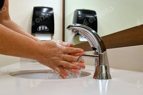 Preview: Washing hands in a public restroom, bathroom. Stop the spread of germs, sickness, colds and illness.