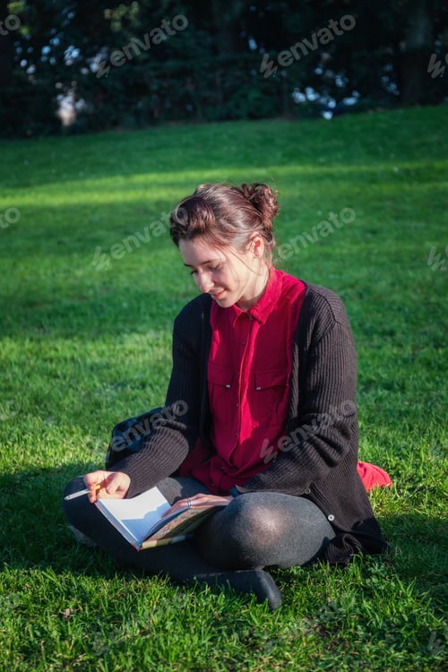 Preview: Girl reads a book and smokes a cigarette.