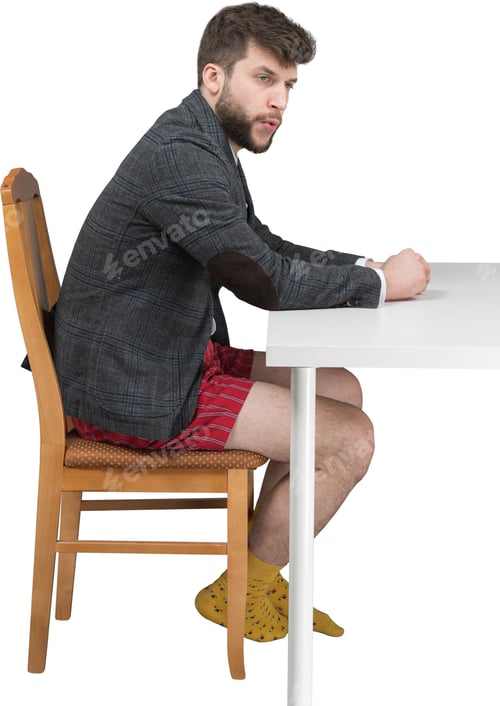 Preview: a man sitting at a table with his feet on a chair