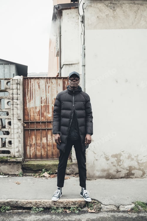 Preview: portrait of young african man standing in the street