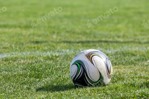 Preview: Soccer or football ball on a grass
