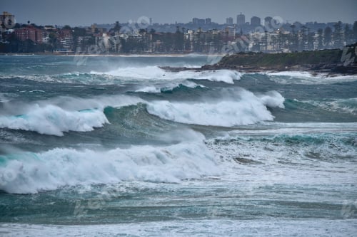 Preview: large waves at North Curl Curl with Sydney Australia in the background