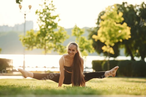 Preview: In the park at sunny daytime. Beautiful young woman in sportive clothes
