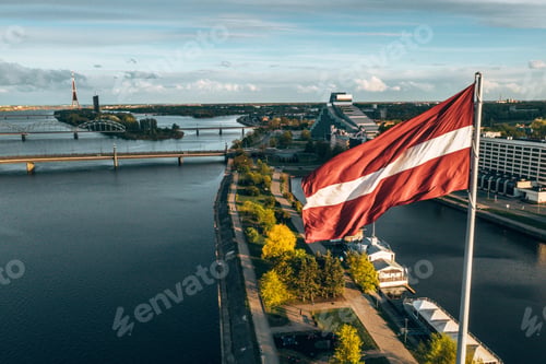 Preview: Aerial shot of Latvia's flag on Riga's cityscape background
