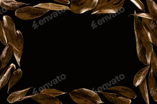 Preview: top view of frame borders made of golden metal leaves isolated on black with copy space