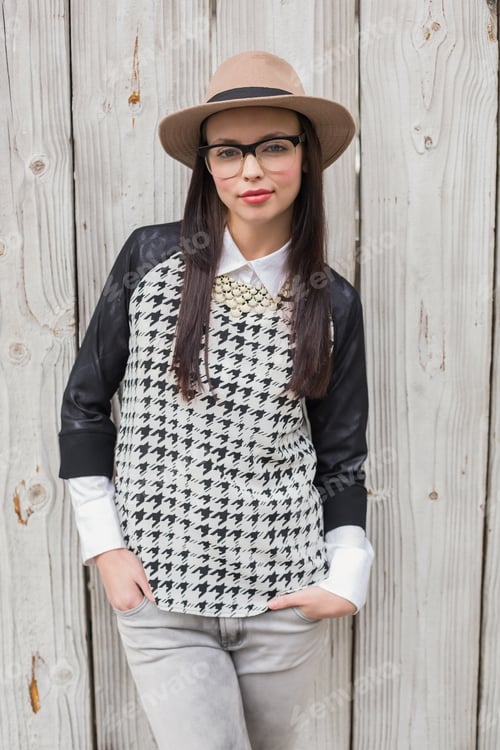 Preview: Pretty hipster posing for camera against bleached wooden planks