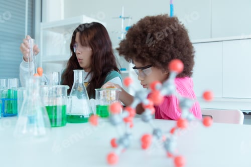 Preview: In the science classroom, an Asian child scientist experimenting with scientific formulas