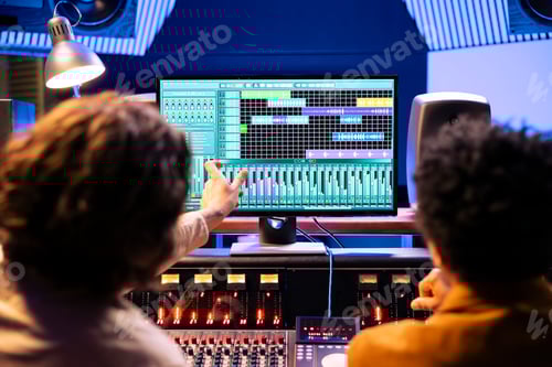 Preview: Men working with Audio Mixing Software in Studio