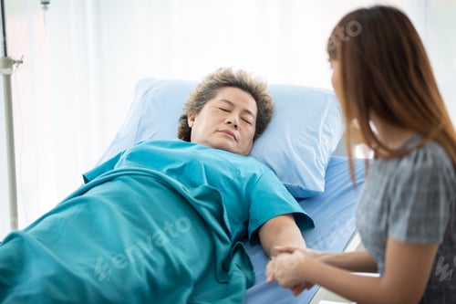 Preview: Doctor or nurse holding elderly lady's hands.