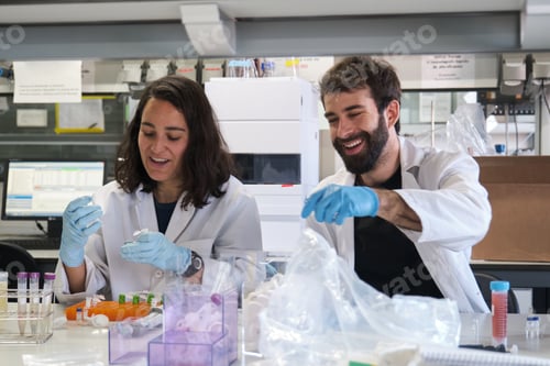 Preview: Two young phD students working in a real laboratory.