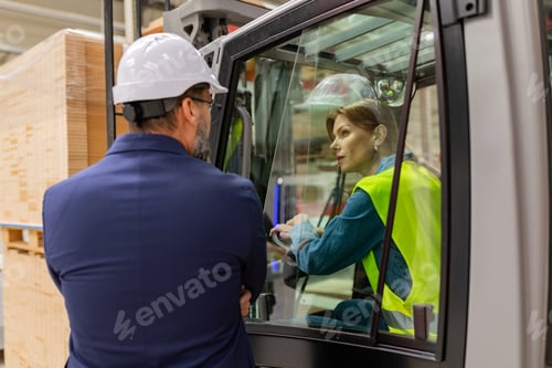 Preview: Female forklift driver talking with manager in warehouse, order picking. Warehouse worker preparing