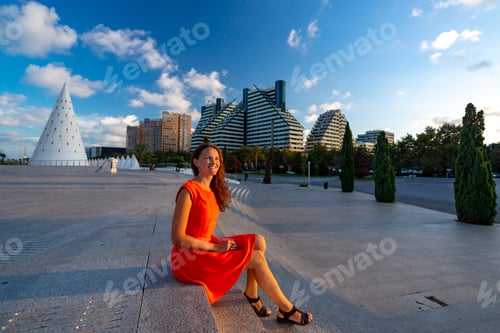 Preview: Girl sitting on the steps at sunset. Valencia, Spain.
