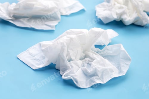 Preview: Crumpled tissue paper. Facial tissue on blue background.