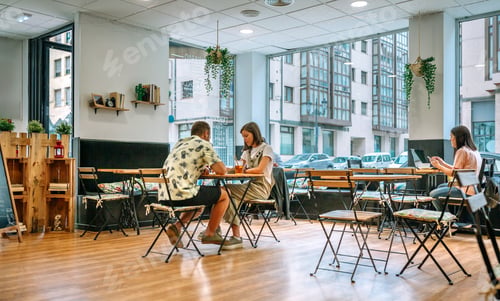 Preview: Customers enjoying relaxing atmosphere in modern cafe