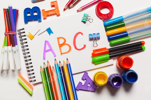 Preview: Colorful school supplies with letters and art materials on a white background