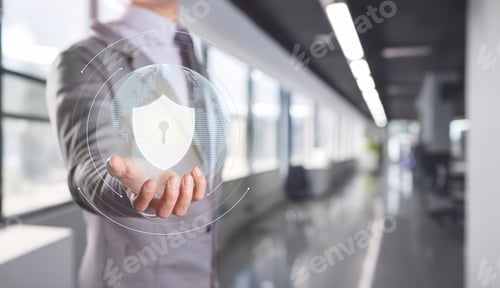 Preview: Businessman Presenting Cybersecurity Shield with Digital Interface in Office