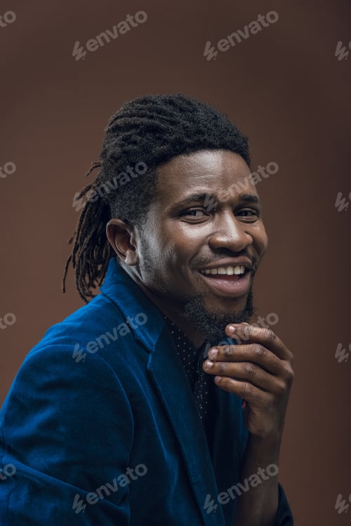 Preview: smiling african american man touching beard isolated on brown