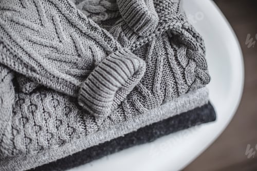 Preview: Close Up of Folded Knitted Gray Sweaters