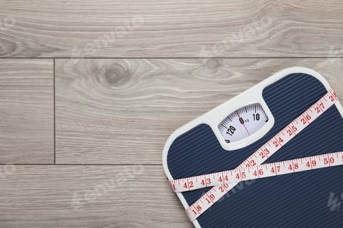 Preview: Scales and measuring tape on wooden background, top view with space for text. Weight loss
