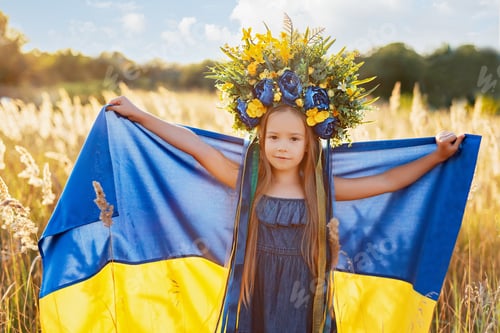 Preview: Girl carries fluttering blue and yellow flag of Ukraine in field