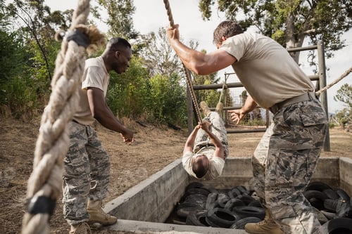 Preview: Young military soldiers practicing rope climbing during obstacle course