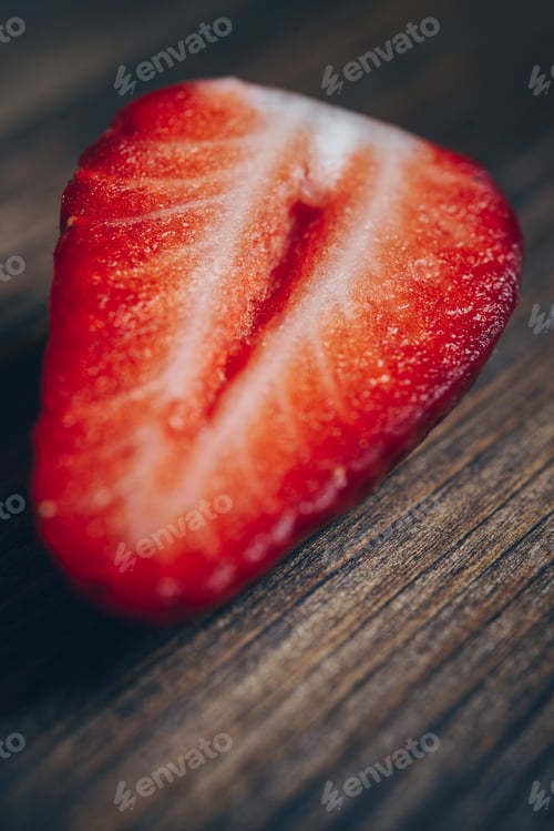 Preview: half juicy strawberry on a wooden table
