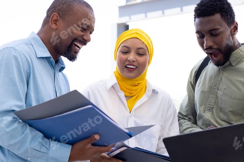 Preview: Happy diverse business people discussing and holding documents outside office