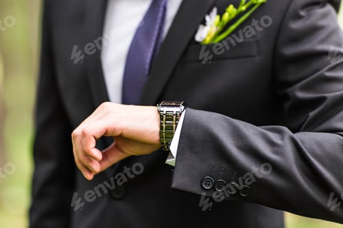 Preview: young business man looking at watch over white background