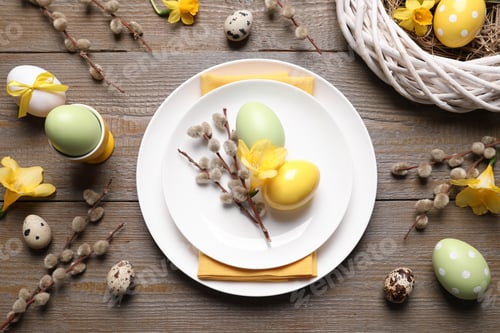 Preview: Festive Easter table setting with painted eggs and floral decor on wooden background, flat lay