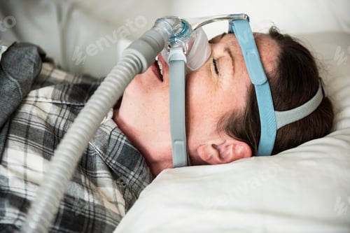 Preview: A woman sleeping with anti snoring chin strap