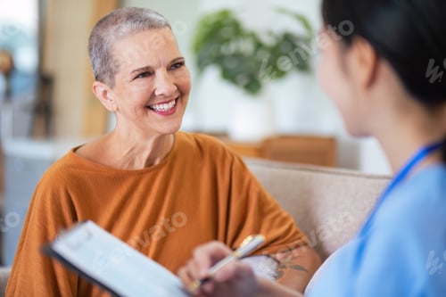 Preview: Asian young woman caregiver doctor give consultation and writing problem of elderly woman patient