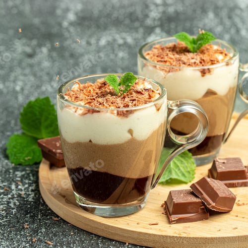 Preview: Dessert three chocolate in a glass jar on a wooden board. Food recipe background. Close up