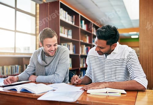 Preview: Lets compare notes. Shot of two university students working together in the library at campus.