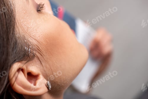 Preview: partial view of young woman with sweat on face suffering from heat on grey