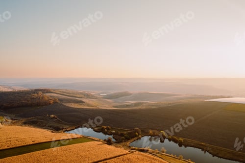 Preview: Aerial view of a Beautiful autumn landscape with fields, hills, trees, lakes. Nature Wallpaper