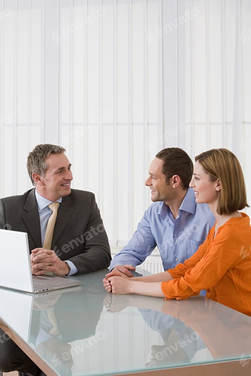 Preview: Man in Meeting With Couple Presenting Laptop