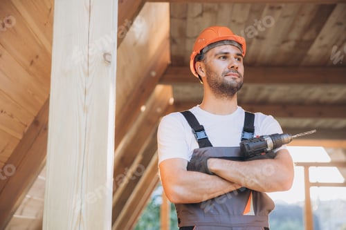 Preview: Man using drill working on construction of wood modular house
