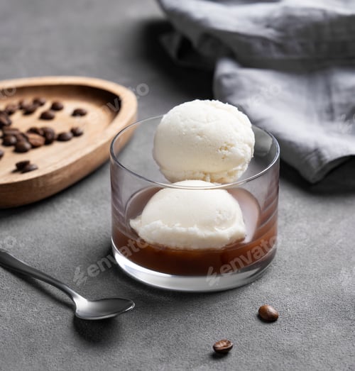 Preview: Affogato coffee with vanilla ice cream scoops and espresso in a glass on a dark background