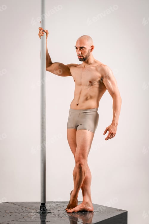 Preview: Muscular male pole dancer posing on stage