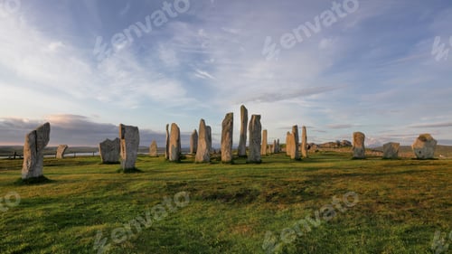 Preview: Callanish standing stones against blue cloudy sky at sunrise in Isle of Lewis, Scotland